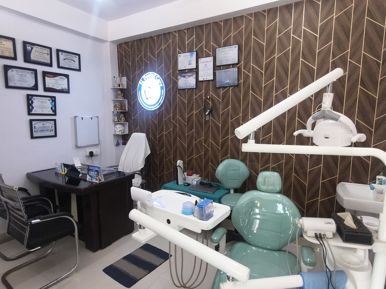 Treatment room with dental chair and certificates wall